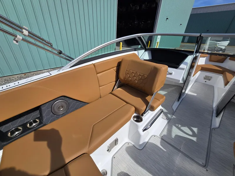 Slide: The Image of 2025 Four Winns H1 boat interior with tan leather seating and modern design. - 16