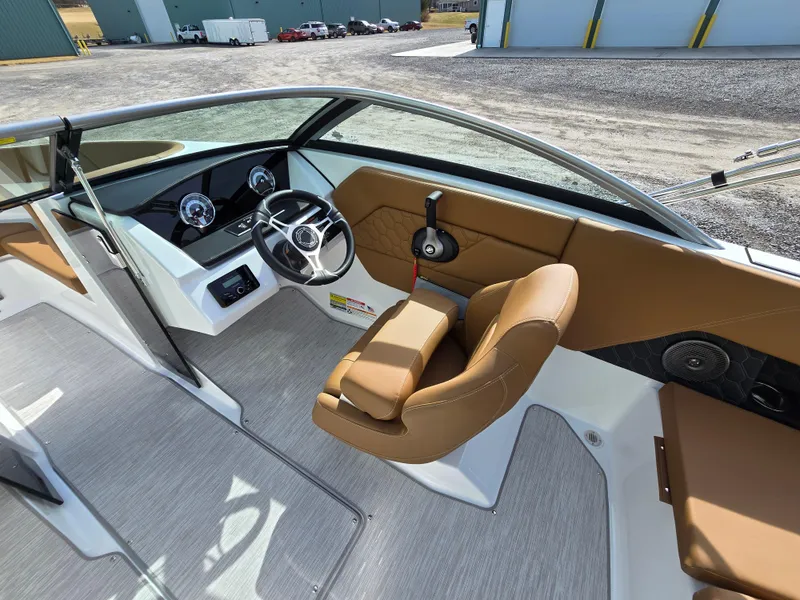 Slide: The Image of 2025 Four Winns H1 boat interior with tan seating and modern dashboard. - 17