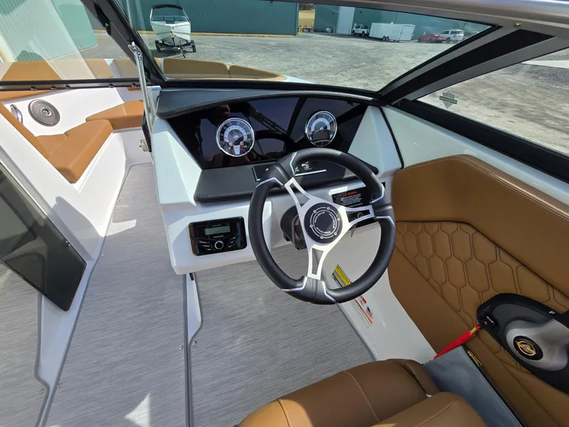 Slide: The Image of 2025 Four Winns H1 boat interior with modern dashboard and brown seating. - 18