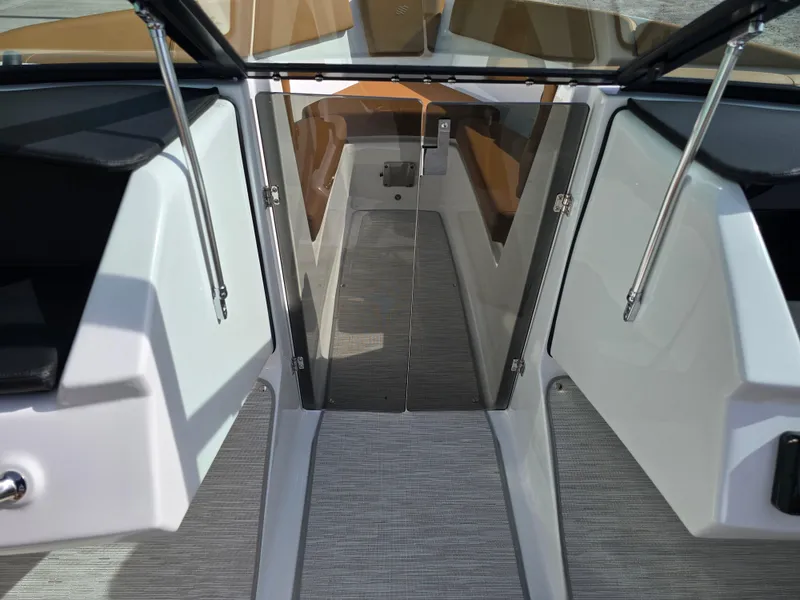 Slide: The Image of 2025 Four Winns H1 boat interior with open glass door and sleek design. - 19