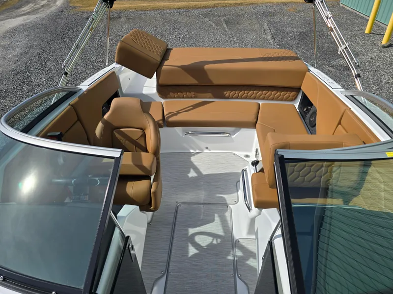 Slide: The Image of 2025 Four Winns H1 boat interior with tan seating and modern design. - 21