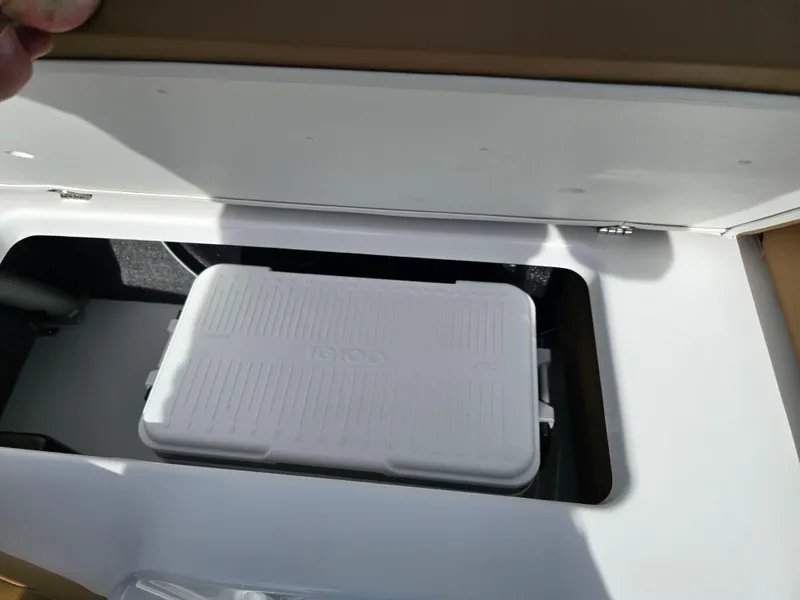 Slide: The Image of Built-in cooler storage in 2025 Four Winns H1 boat. - 23