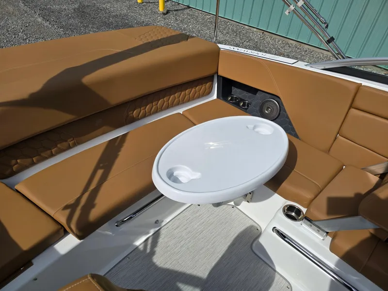 Slide: The Image of 2025 Four Winns H1 boat interior with tan seating and a white table. - 28