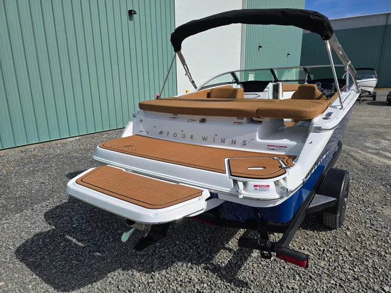 Slide: The Image of 2025 Four Winns H1 boat on trailer, featuring sleek design and spacious deck. - 5