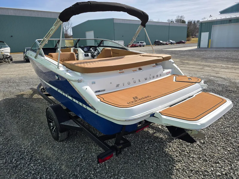 Slide: The Image of 2025 Four Winns H1 boat on trailer, featuring sleek design and spacious seating. - 6