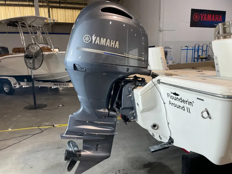 Slide: The Image of 2021 Key West 210 Bay Reef with Yamaha outboard motor in a showroom. - 10