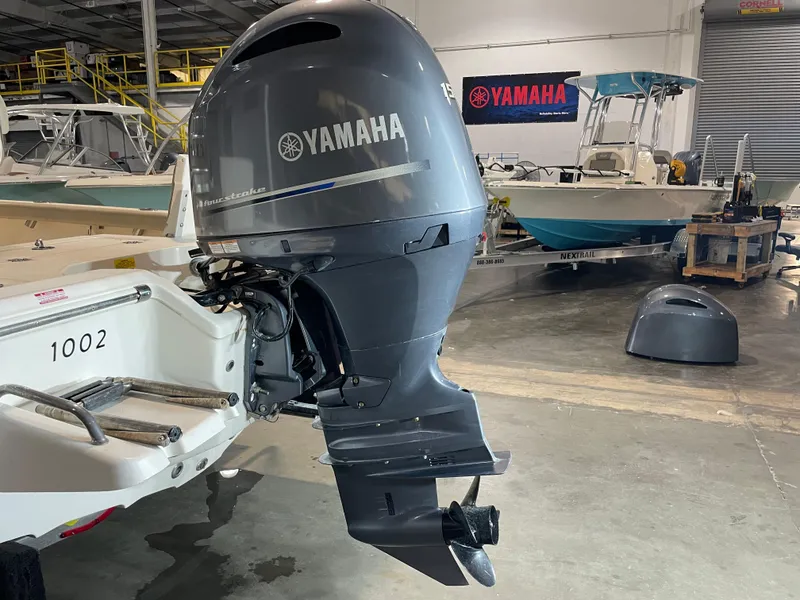 Slide: The Image of 2021 Key West 210 Bay Reef with Yamaha outboard motor in a showroom. - 11