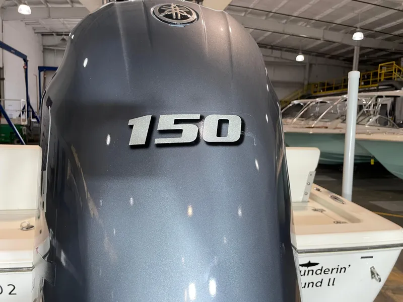 Slide: The Image of Outboard motor with "150" label on a 2021 Key West 210 Bay Reef boat. - 12