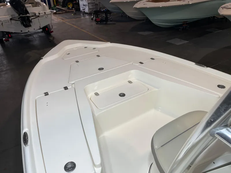 Slide: The Image of 2021 Key West 210 Bay Reef boat interior, featuring spacious deck and storage compartments. - 14