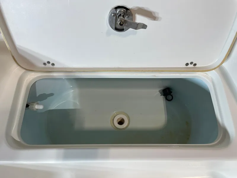 Slide: The Image of Open storage compartment on a 2021 Key West 210 Bay Reef boat. - 16