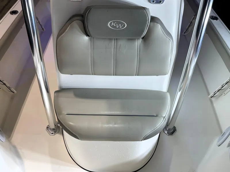 Slide: The Image of 2021 Key West 210 Bay Reef boat seat with gray upholstery and chrome supports. - 20