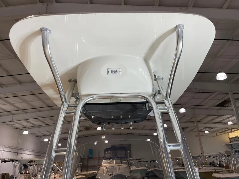 Slide: The Image of 2021 Key West 210 Bay Reef boat T-top and ladder in showroom. - 21
