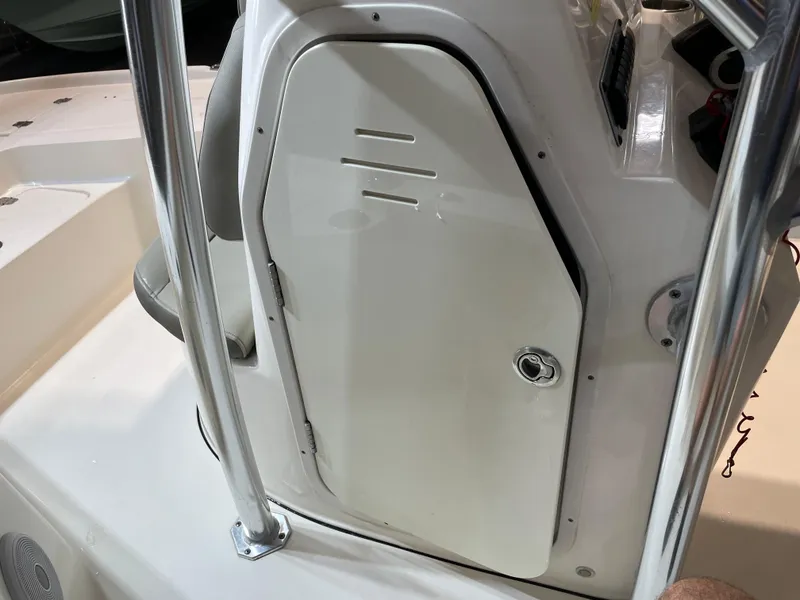 Slide: The Image of 2021 Key West 210 Bay Reef boat console with storage compartment and stainless steel railing. - 24