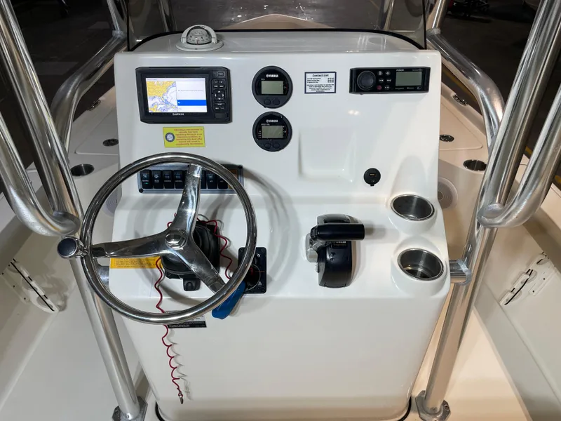 Slide: The Image of 2021 Key West 210 Bay Reef boat console with steering wheel, GPS, and controls. - 26