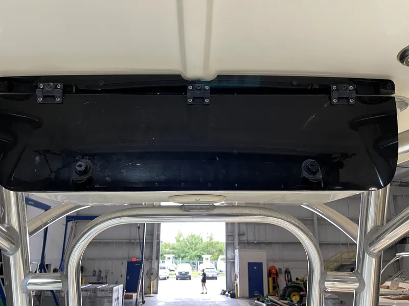 Slide: The Image of 2021 Key West 210 Bay Reef boat interior, featuring a black panel and metal framework. - 27