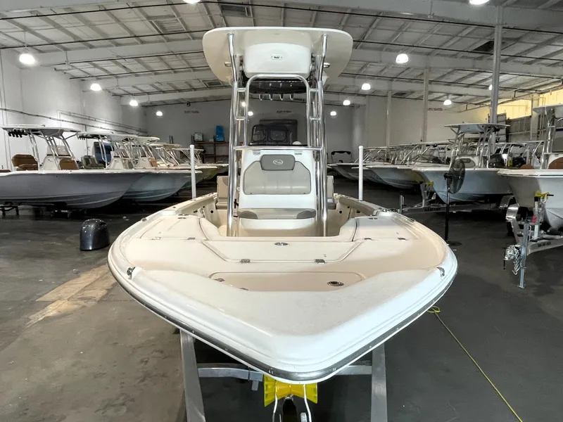Slide: The Image of 2021 Key West 210 Bay Reef boat in a showroom, surrounded by other boats. - 3
