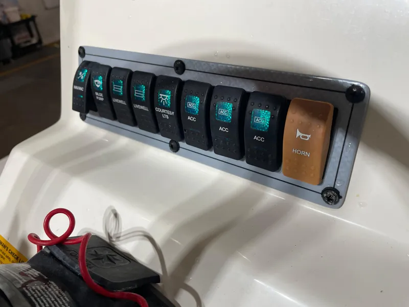 Slide: The Image of Control panel of a 2021 Key West 210 Bay Reef boat with labeled switches. - 31