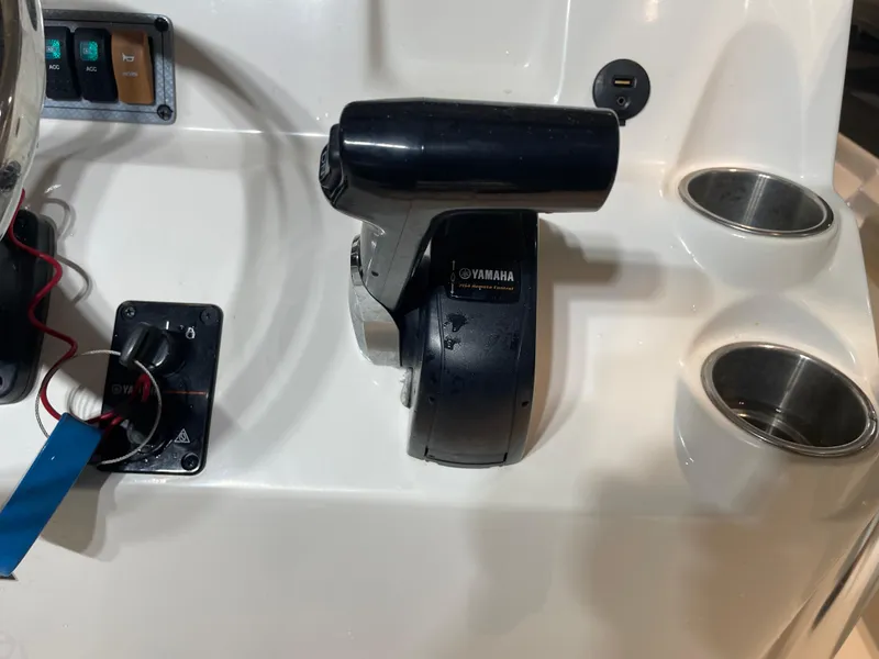 Slide: The Image of Boat control panel with Yamaha throttle, cup holders, and switches on a 2021 Key West 210 Bay Reef. - 32