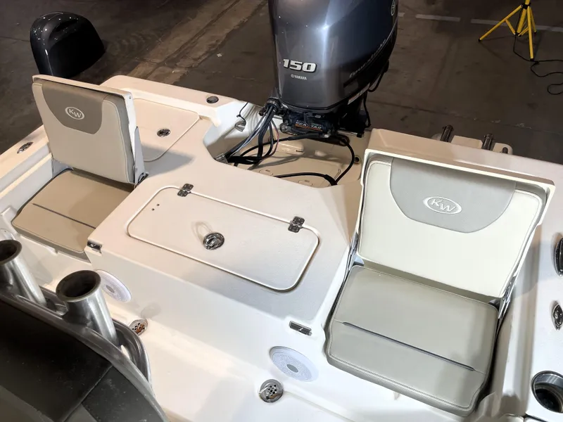Slide: The Image of 2021 Key West 210 Bay Reef boat interior with Yamaha 150 engine, featuring seating and storage. - 35