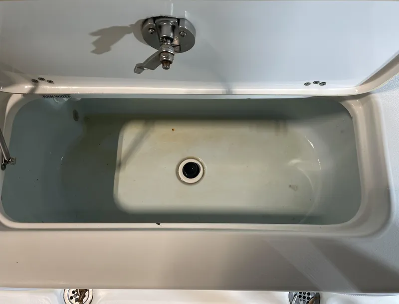 Slide: The Image of Livewell in 2021 Key West 210 Bay Reef boat, partially filled with water. - 36