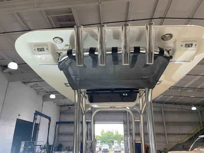 Slide: The Image of 2021 Key West 210 Bay Reef boat with T-top and rod holders in a warehouse. - 38