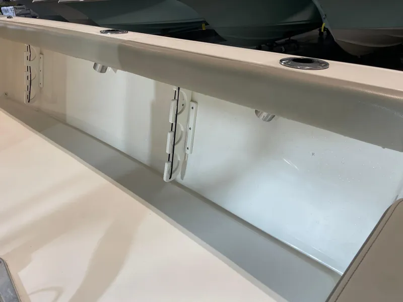 Slide: The Image of 2021 Key West 210 Bay Reef boat interior detail with rod holders and storage compartment. - 40