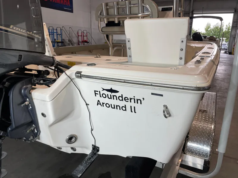Slide: The Image of 2021 Key West 210 Bay Reef boat with "Flounderin' Around II" name, in a garage. - 9
