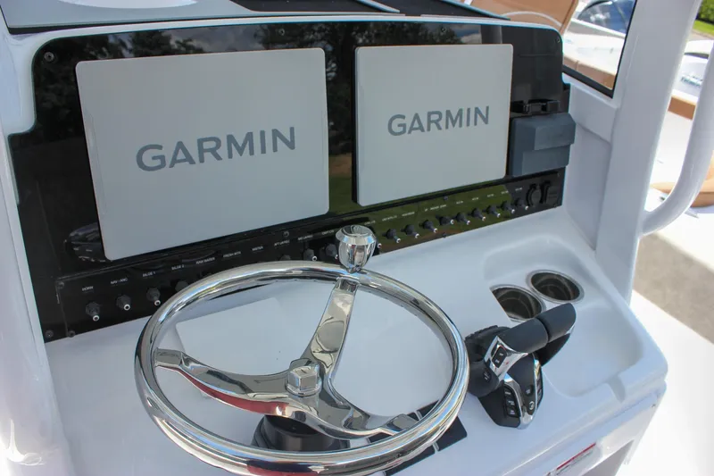 Slide: The Image of Helm of 2026 Sea Hunt Ultra 265 SE with Garmin displays and controls. - 14