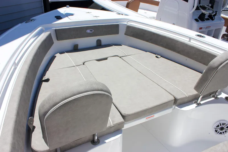 Slide: The Image of 2026 Sea Hunt Ultra 265 SE boat with spacious cushioned seating area. - 16