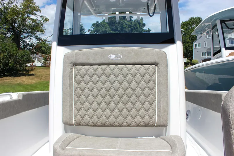 Slide: The Image of 2026 Sea Hunt Ultra 265 SE boat seat with diamond-pattern upholstery, outdoor setting. - 17