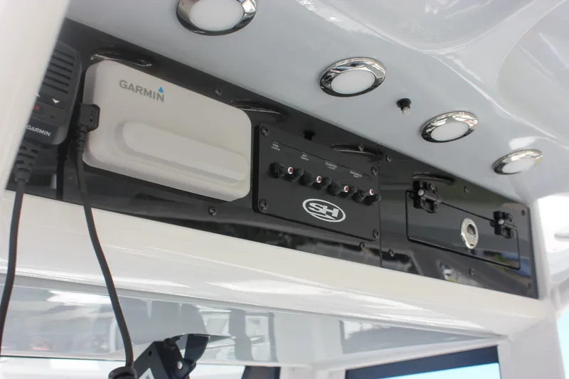 Slide: The Image of 2026 Sea Hunt Ultra 265 SE dashboard with Garmin electronics and control panel. - 33