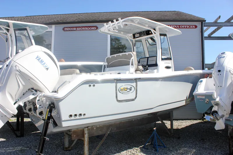 Slide: The Image of 2026 Sea Hunt Ultra 265 SE boat with Yamaha engines displayed outdoors. - 34