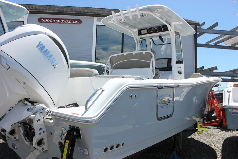Slide: The Image of 2026 Sea Hunt Ultra 265 SE boat with Yamaha engine, displayed outdoors near showroom. - 4