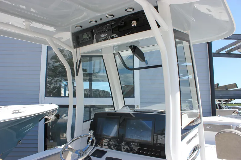 Slide: The Image of 2026 Sea Hunt Ultra 265 SE boat cockpit with modern navigation equipment and sleek design. - 44