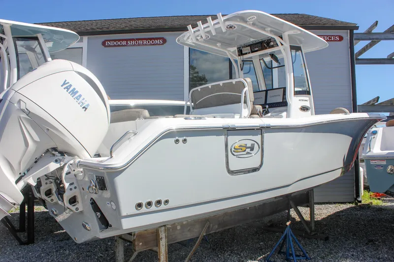 Slide: The Image of 2026 Sea Hunt Ultra 265 SE boat with Yamaha engine displayed outdoors. - 46
