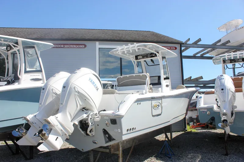 Slide: The Image of 2026 Sea Hunt Ultra 265 SE boat with Yamaha engines displayed outdoors. - 47