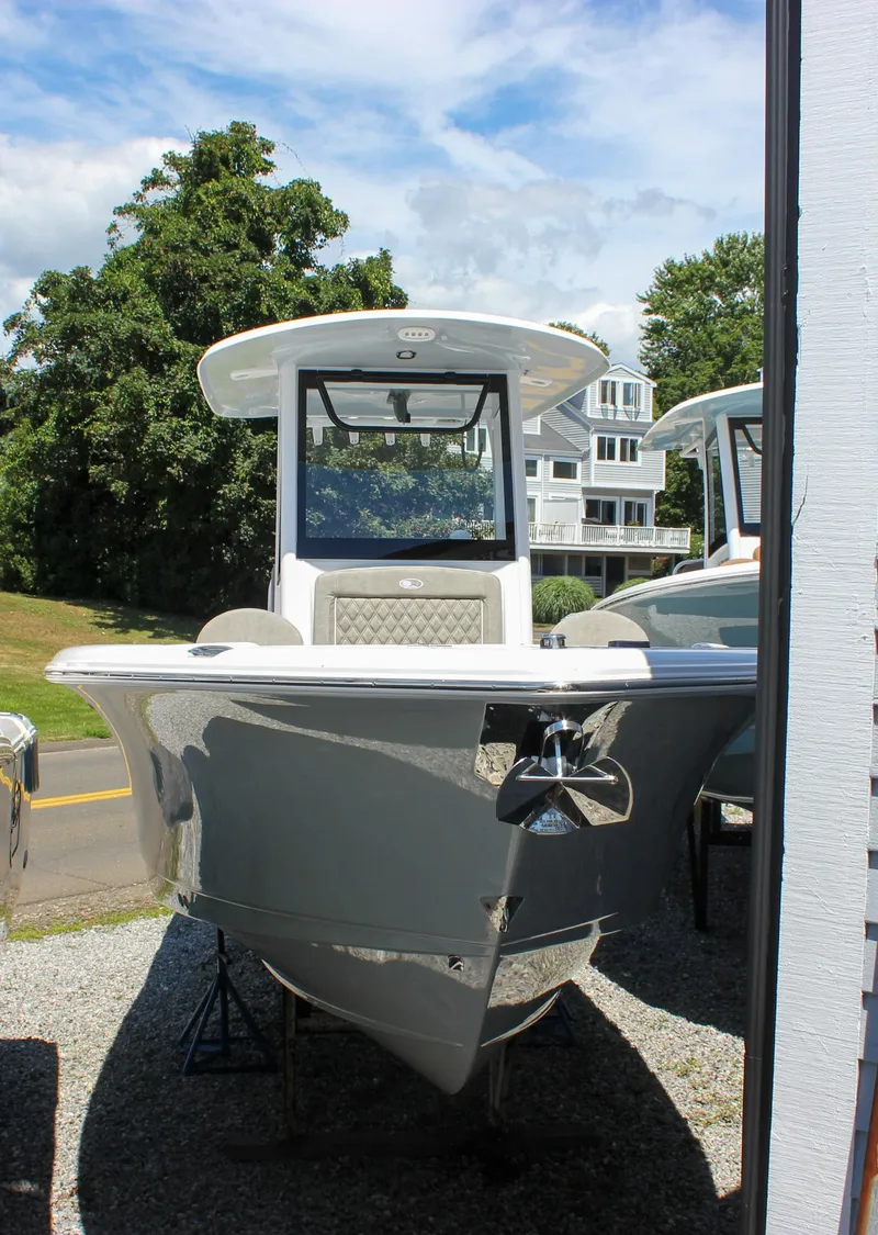 Slide: The Image of 2026 Sea Hunt Ultra 265 SE boat displayed outdoors on gravel. - 48