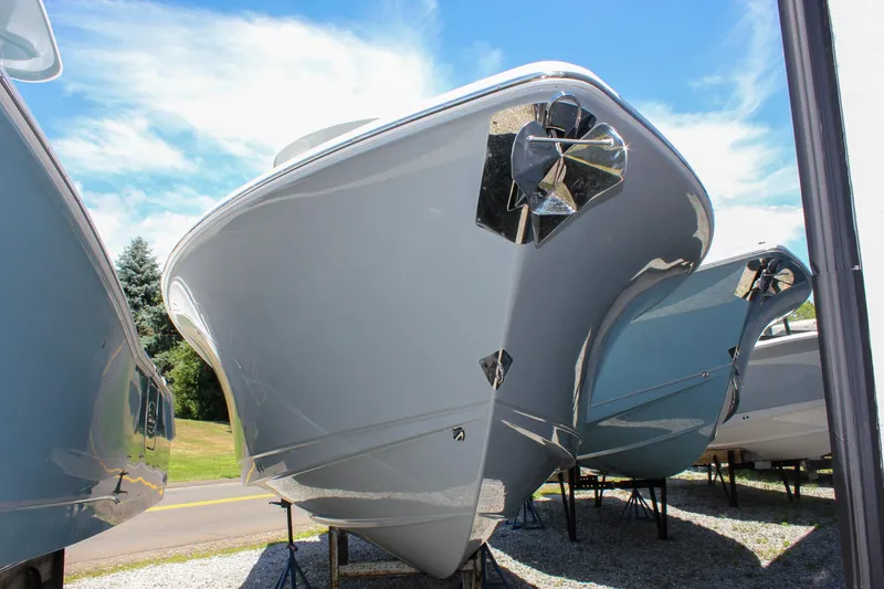 Slide: The Image of 2026 Sea Hunt Ultra 265 SE boat displayed outdoors under a clear blue sky. - 49
