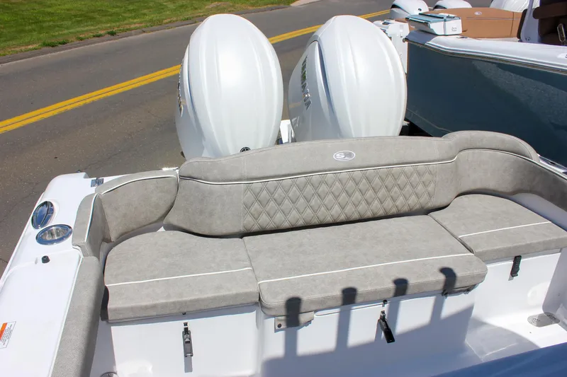 Slide: The Image of 2026 Sea Hunt Ultra 265 SE boat with cushioned seating and dual outboard motors. - 5