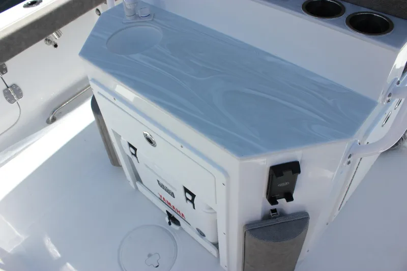 Slide: The Image of Interior of 2026 Sea Hunt Ultra 265 SE boat with sleek countertop and cup holders. - 6