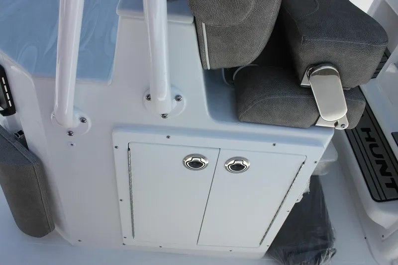 Slide: The Image of 2026 Sea Hunt Ultra 265 SE boat interior with gray seating and storage compartments. - 8