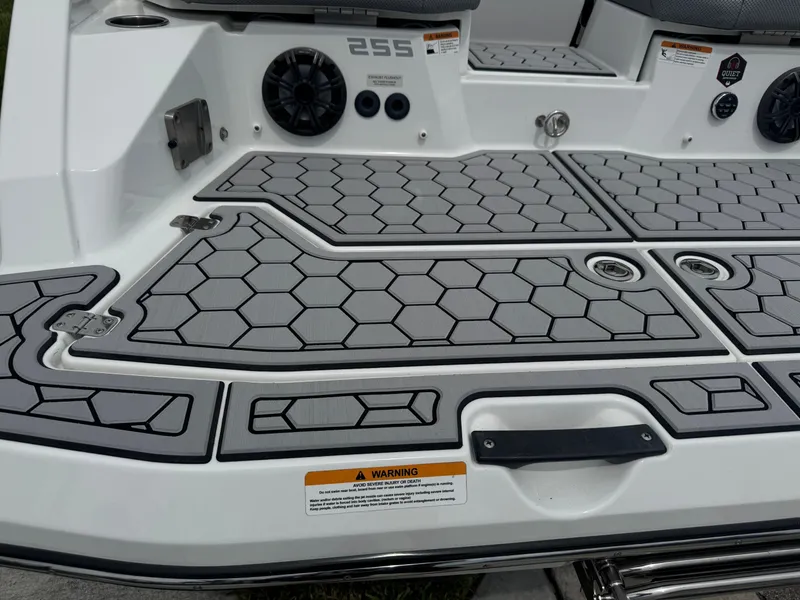 Slide: The Image of 2020 Scarab 255 Open ID boat deck with hexagonal pattern and speakers. - 10