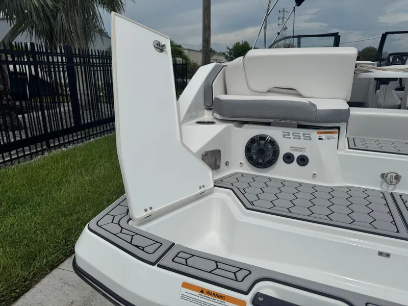 Slide: The Image of 2020 Scarab 255 Open ID boat interior with open storage compartment and seating. - 12