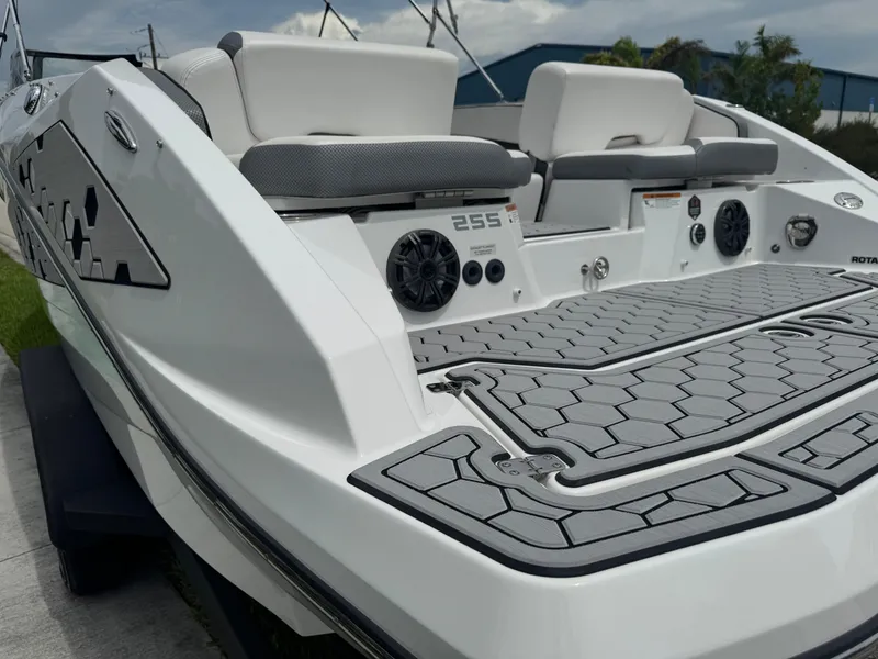Slide: The Image of 2020 Scarab 255 Open ID boat, rear view with seating and speakers, on a sunny day. - 16