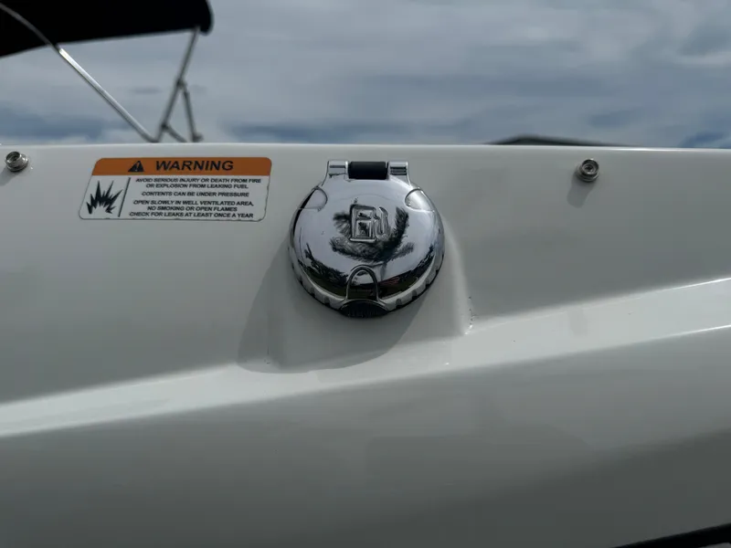 Slide: The Image of 2020 Scarab 255 Open ID boat fuel cap with warning label. - 19
