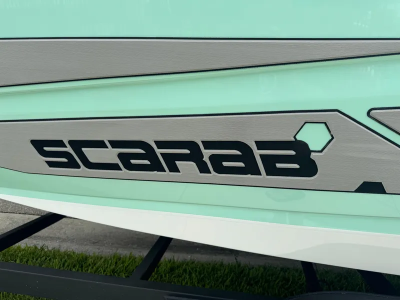Slide: The Image of 2020 Scarab 255 Open ID boat logo on mint green hull. - 21
