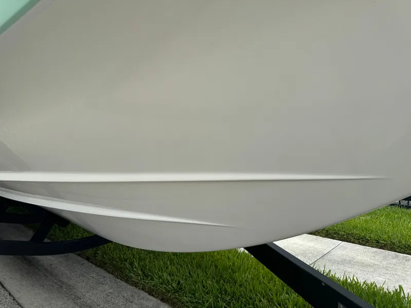 Slide: The Image of 2020 Scarab 255 Open ID boat hull on trailer, close-up view. - 30