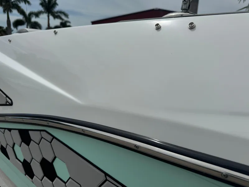 Slide: The Image of 2020 Scarab 255 Open ID boat with hexagonal pattern detail and sleek white finish. - 34