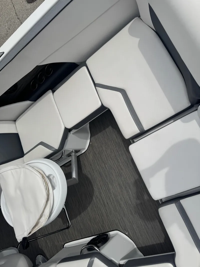 Slide: The Image of 2020 Scarab 255 Open ID boat interior with white cushioned seating and modern design. - 38