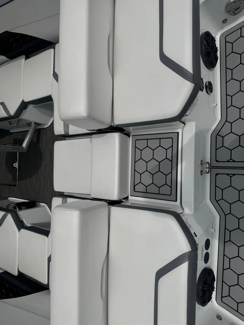 Slide: The Image of 2020 Scarab 255 Open ID boat interior with white cushioned seating and hexagonal patterned flooring. - 42